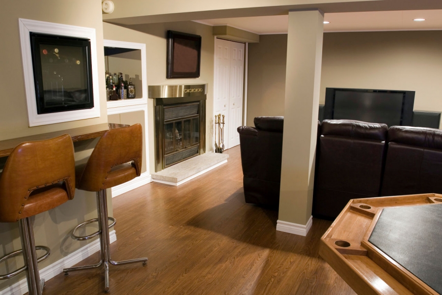 Finished basement man cave with bar and fireplace