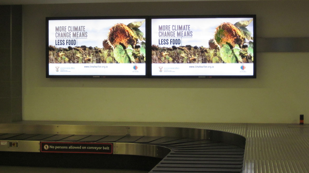 Climate education at the baggage carousel…perhaps the most promising place to attract attention.