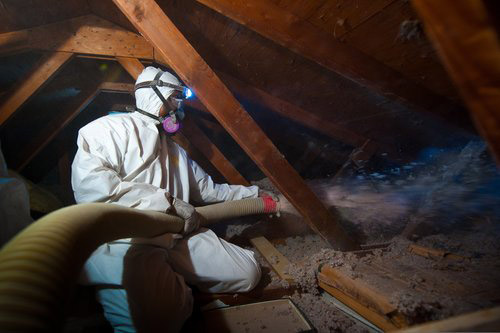 Spraying insulation into an attic - Credit Dennis SchroederNREL
