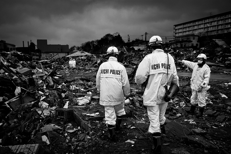 Japanese officials surveying the damaged caused by the tsunami