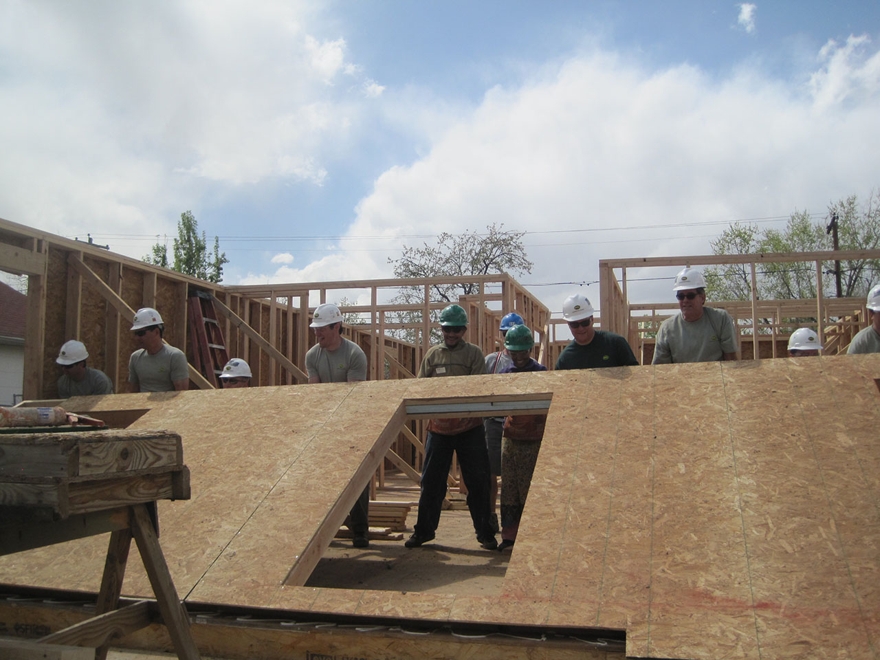 Habitat for Humanity volunteers raise a wall