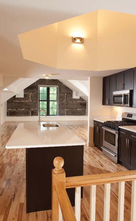 A kitchen inside a residence of the old Salem Jail in Massachusetts converted  into a residential complex by FA+A.