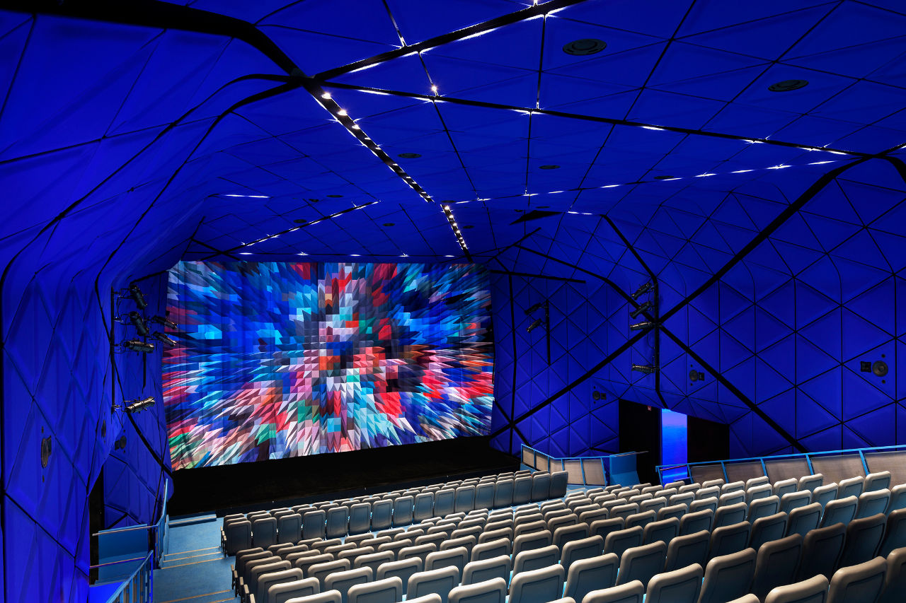 The Theater inside of New York City's Museum of the Moving Image designed by Leeser Architecture lined with electric Yves Klein blue felt panels
