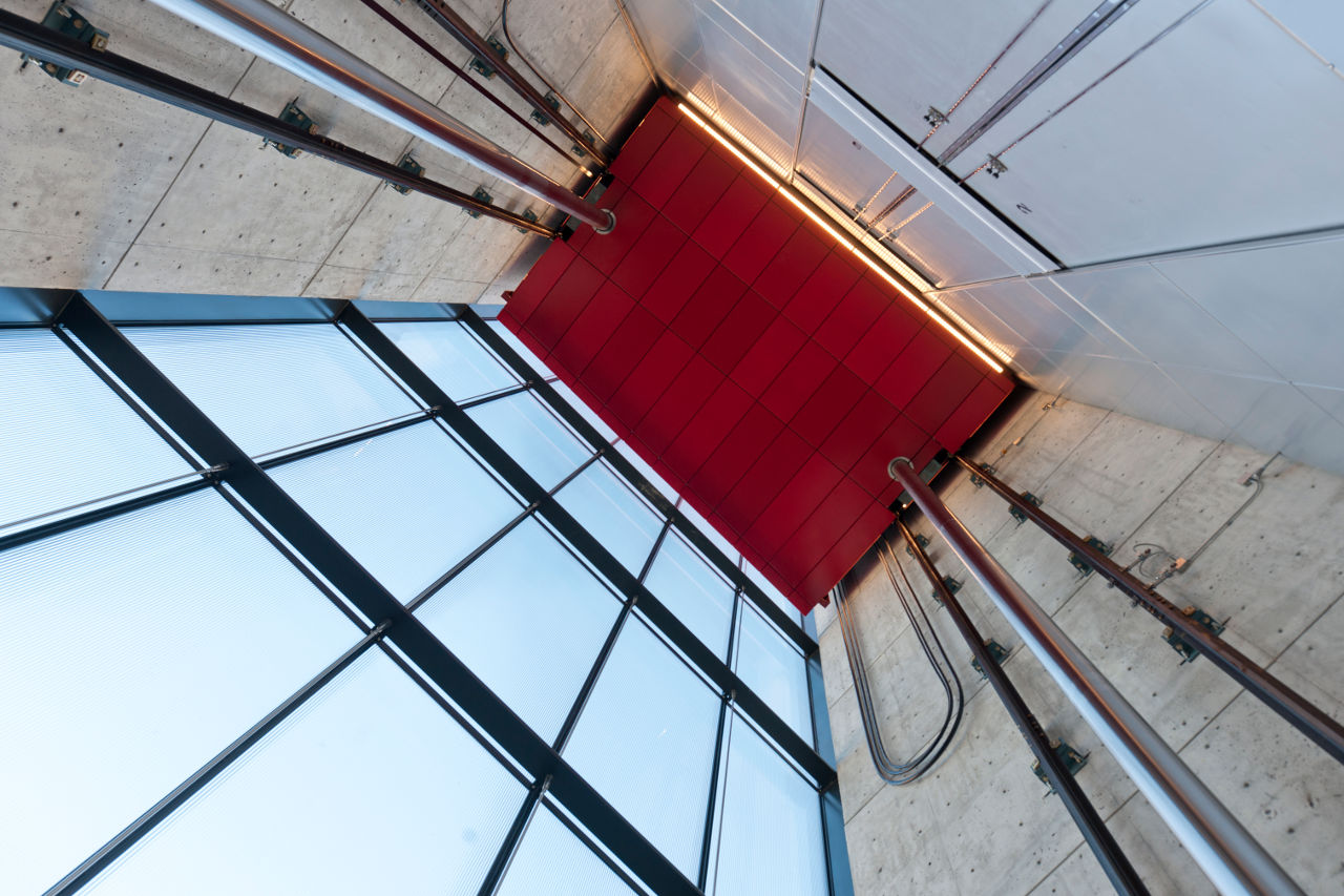 The signature red elevator inside of New York City's Sperone Westwater Gallery by Foster + Partners