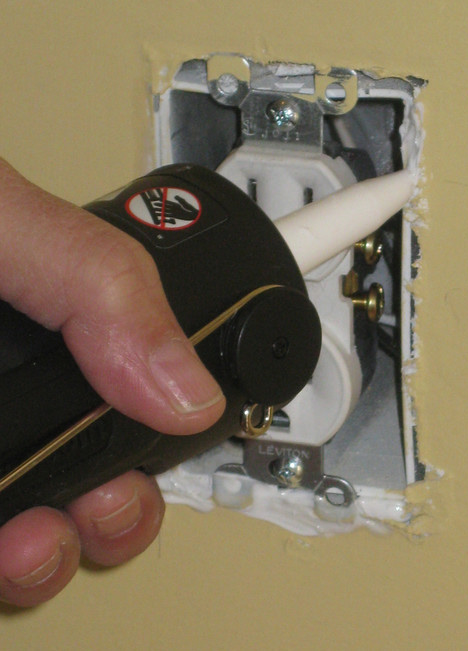 Caulking around a wall switch