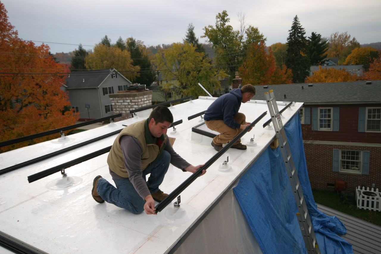 installing the base for a solar panel array on the roof
