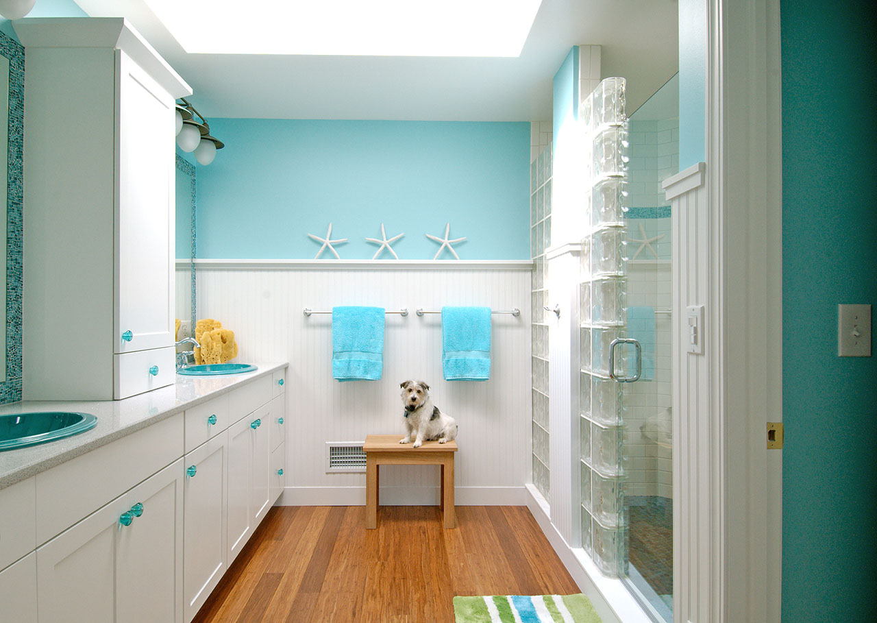 remodeled bathroom in ocean colors with white cabinets