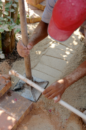 Compacting the gravel base before installing the dry laid paver patio