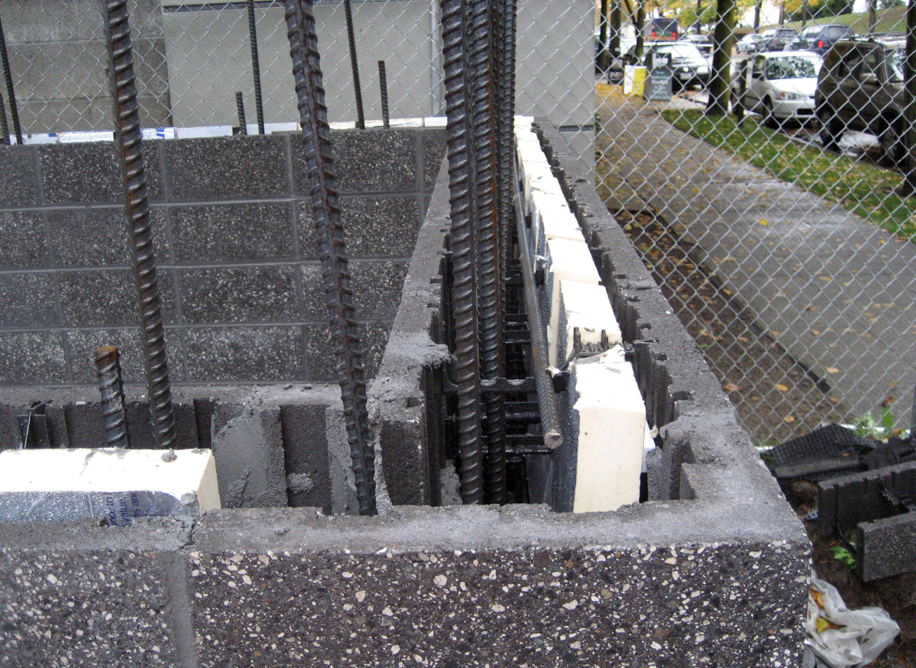 Sustainable concrete form masonry (CMFU) blocks with insulation and rebar
