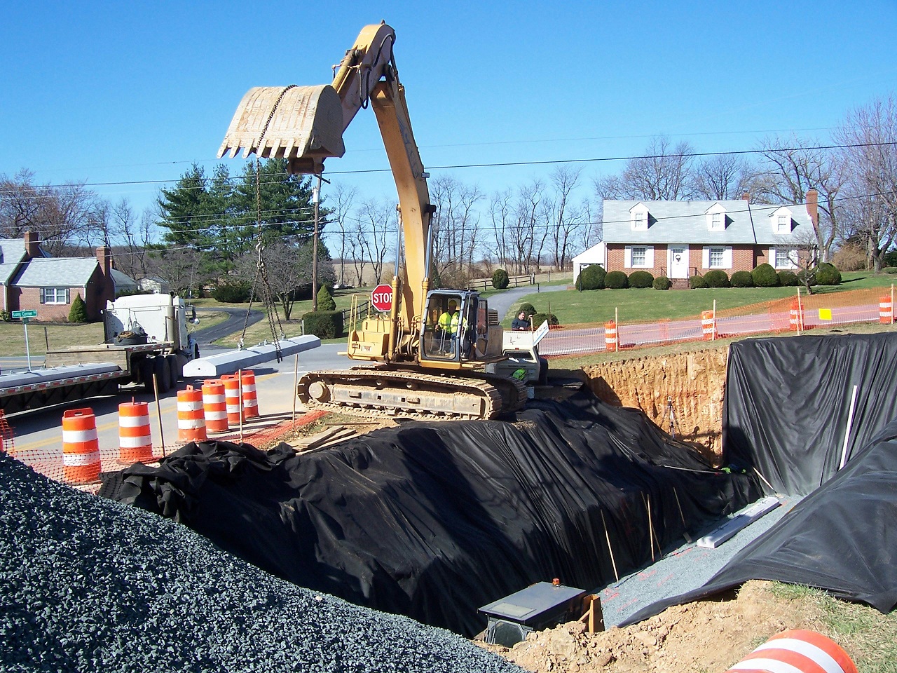 using a backhoe to dig the hole for an underground storage tank