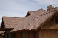 Autumn blend of DaVinci Multi-Width Shake roofing tiles accented by copper valleys.