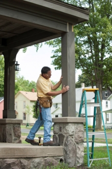 The completed column wrap is inspected by contractor Steve Roth after being finished. 